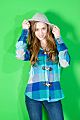 Girl in front of a green background