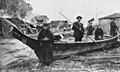 Klallam people near canoe