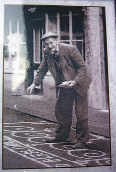 Man Sanding the street in Knutsfrod for May Day 1920