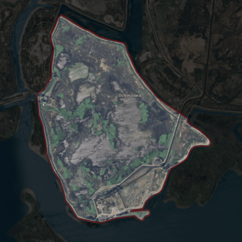 Aerial photo of a sad island surrounded by muck.