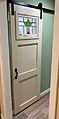 Sliding pantry door installed in a suburban home