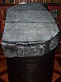"Replica of the Rosetta Stone in the King's Library of the British Museum as it would have appeared to 19th century visitors, which was open to the air, held in a cradle that is at a slight angle from the horizontal and available to touch"