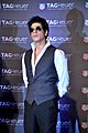 Shah Rukh Khan wearing sunglasses and a vest at a promotional event
