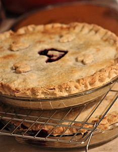 Cherry pie with heart in center, on baking rack with other pies (31109649422)