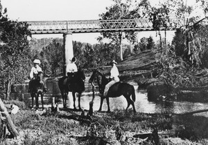 Horse riders by the railway bridge which crosses the Wide Bay Creek near Woolooga Station Queensland, circa 1912f