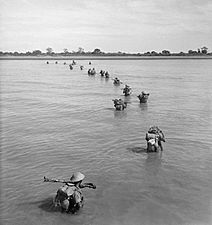 Indian troops wade ashore at Akyab, Burma, January 1945. SE2418