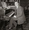 Rachmaninoff seated at Steinway grand piano