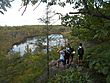A group of hikers overlook a lake in Abram S. Hewitt State Forest in New Jersey.