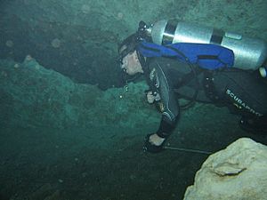 Cave diver running a reel