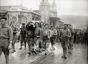 Soldados del bando nacional llevando a hombros un féretro por la avenida de la Zurriola (1 de 1) - Fondo Car-Kutxa Fototeka