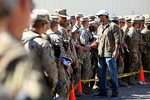 Vincent Jackson, center, a wide receiver for the Tampa Bay Buccaneers, shakes hands with U.S. Service members after a visit sponsored by the USO at Camp Leatherneck, Helmand province, Afghanistan, March 1 130301-M-KS710-074
