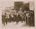 Caliph Abdülmecid walking with entourage of soldiers, officials and a brass band as women watch LCCN2011649919 (cropped)