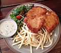 Chicken schnitzel with fries and salad