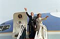 Former President and First Lady Carter wave from their aircraft