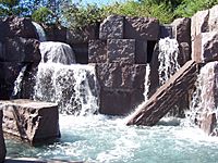 Waterfalls flowing over stone blocks into a pool