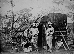 StateLibQld 1 102208 Gold miners outside a bark hut, Queensland, ca. 1870