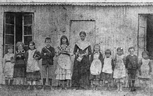 StateLibQld 2 292547 School children and teacher portrait at the Provisional School, Mount Britton, 1885