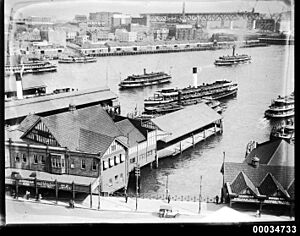 Circular Quay from south eastern corner with view of Sydney Harbour Bridge under construction, c 1926 (8165886240)