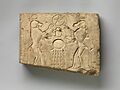 Relief panel showing two baboons offering the wedjat eye to the sun god Khepri, who holds the Underworld sign MET DP241031