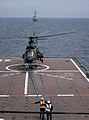 Republic of Singapore Air Force Eurocopter AS332 Super Puma taking off from the RSS Resolution with the USS Russell on the horizon - 20040607