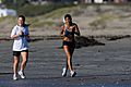 Girls jog along Morro Strand State Beach