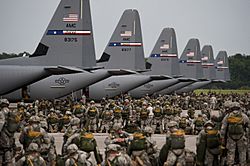 Soldiers from the US Army’s 82nd Airborne Division prepare for a mass parachute jump from US Air Force C-130J Hercules aircraft during a Joint Operation Access exercise at Pope Field in 2013.