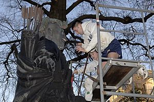US Navy 051130-N-5390M-004 U.S. Naval Academy Midshipman Lauren Eanes and Midshipman Kevin Omalley paint the statue of Tecumseh