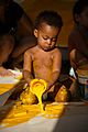 Baby playing with yellow paint. Work by Dutch artist Peter Klashorst entitled "Experimental"