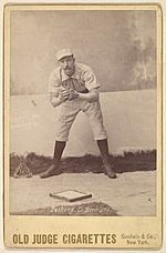 Doc Bushong in 1888 Old Judge baseball card, crouching position