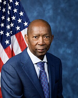 Official House portrait of Turner smiling in front of the U.S. flag, wearing a black jacket, light blue shirt, and floral blue tie.