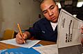 US Navy 050223-N-5821P-054 Seaman Chanthorn Peou of San Diego, Calif., takes his Scholastic Aptitude Test (SAT) aboard the conventionally powered aircraft carrier USS Kitty Hawk (CV 63)