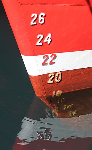 Draft marks on a ship's bow, with reflections