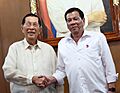 President Rodrigo Roa Duterte shakes hands with Former Senator Juan Ponce Enrile