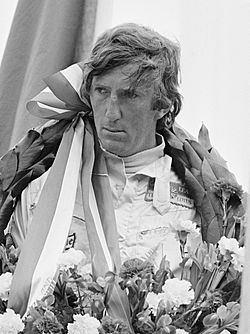 Photograph of Jochen Rindt on a winner's rostrum with a laurel wreath around his neck
