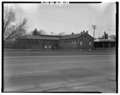 IMAGE OF THE CONCRETE PARAPET, NORTHEAST SIDE OF THE BRIDGE, WITH A 19TH CENTURY FACTORY (NOW ABANDONED) IN THE BACKGROUND. THE ELEVATED RAILROAD BRIDGE OVER US 40 IS ALSO SHOWN HAER IND,89-RICH,14-9