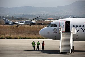 Russian Air Force Sukhoi Su-24 passes a Syrianair Airbus A320 at Latakia