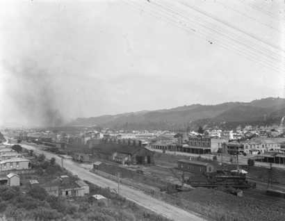 View looking over Taumarunui Railway Station and railway yards in the foreground, with the township beyond. ATLIB 292643.png