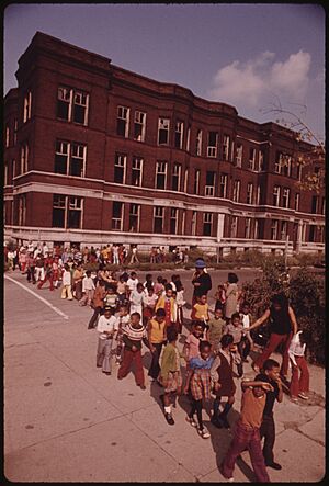 YOUNGSTERS RETURNING TO CLASS FOLLOWING A FIRE DRILL IN A CHICAGO ELEMENTARY SCHOOL. FIRE DRILLS ASSUME A GREATER... - NARA - 556265