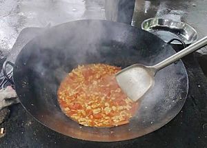 Cooking with a wok on an outdoor stove 5