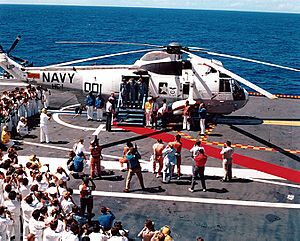 Apollo 16 crew exits recovery helicopter aboard Ticonderoga