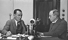 NSW Politicians Mr. Tom Shannon and J. J. Cahill talking at a desk, New South Wales, c. 1930s