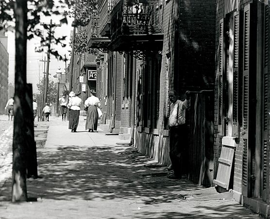 Pedestrians walk on South Eighth Street in Soulard