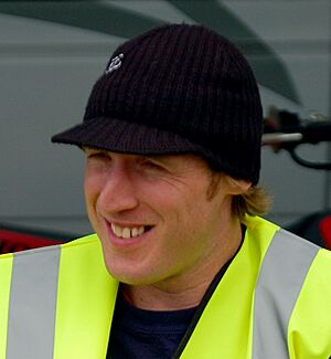 Headshot of a smiling Peat in a safety vest and a hat