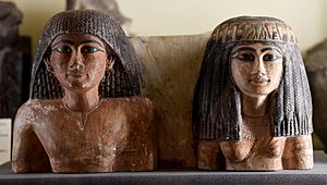 Upper part of a statuette of an Egyptian man and his wife. 18th Dynasty. From Egypt. From the Amelia Edwards Collection. Now housed in the Petrie Museum of Egyptian Archaeology, London