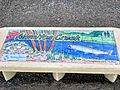 A bench with painted tiles by the Los Alamitos Creek