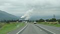 Approaching Tully from the south on the Bruce Highway, the steam rising is from the Tully Sugar Mill, 2016