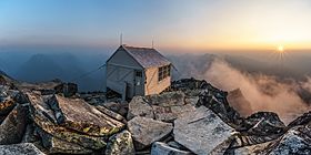 Hidden Peak Fire Lookout at sunset, with smokey haze from nearby fires