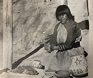Maria Martinez making pottery at her house in 1905