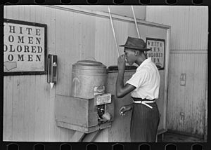 Negro drinking at "Colored" water cooler in streetcar terminal, Oklahoma City, Oklahoma LOC 15359682455