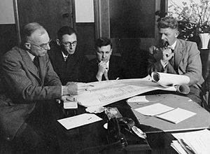Professors John Eccles, Adrien Albert, Frank Fenner and Hugh Ennor study the plans for the proposed new John Curtin School of Medical Research